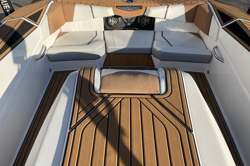 Slide: The Image of 2023 Nautique Ski Nautique boat interior with luxurious seating and teak flooring. - 11