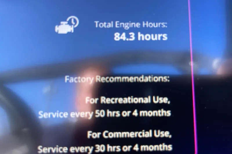 Slide: The Image of 2023 Nautique Ski Nautique display showing 84.3 engine hours and service recommendations. - 12