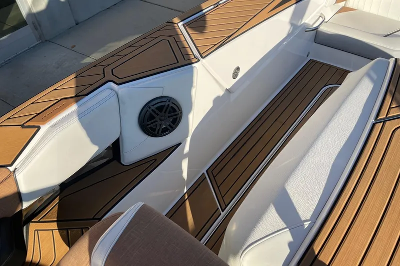 Slide: The Image of 2023 Nautique Ski Nautique interior with sleek wood finish and comfortable seating. - 6