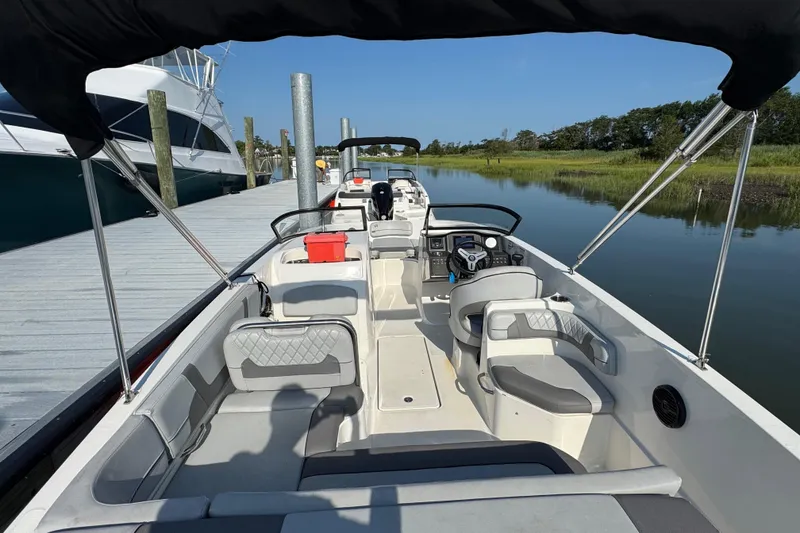 Slide: The Image of 2023 Bayliner VR6 Bowrider OB docked, showcasing spacious interior and sleek design. - 2