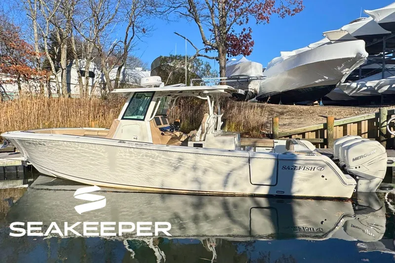 The Image of 2020 Sailfish 360 CC boat on calm blue water with Seakeeper logo. - 0