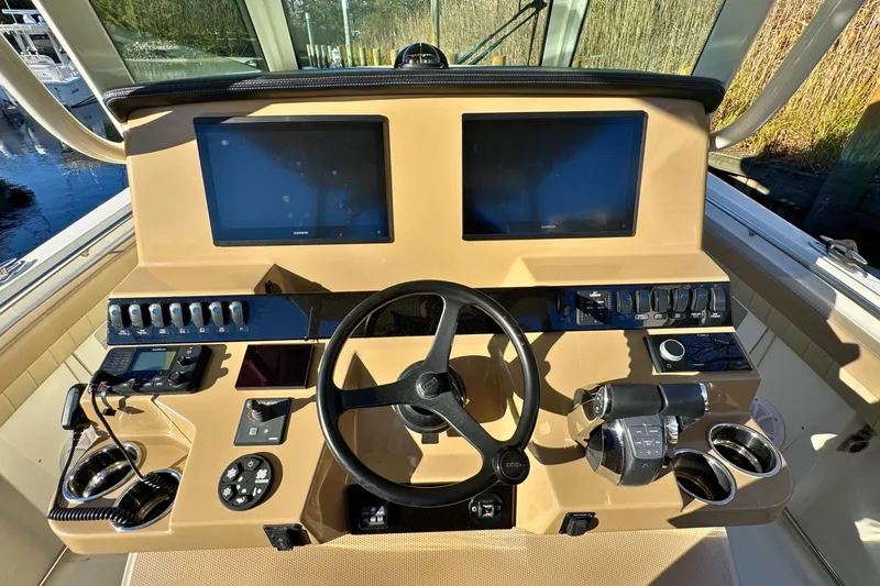 Slide: The Image of 2020 Sailfish 360 CC boat interior with control panel and storage compartments. - 17