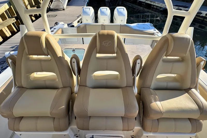 Slide: The Image of Control panel of a 2020 Sailfish 360 CC boat with various switches and a Fusion audio system. - 23