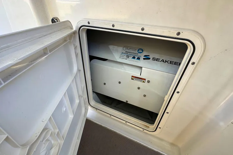 Slide: The Image of 2020 Sailfish 360 CC boat interior with beige seats on open water. - 26