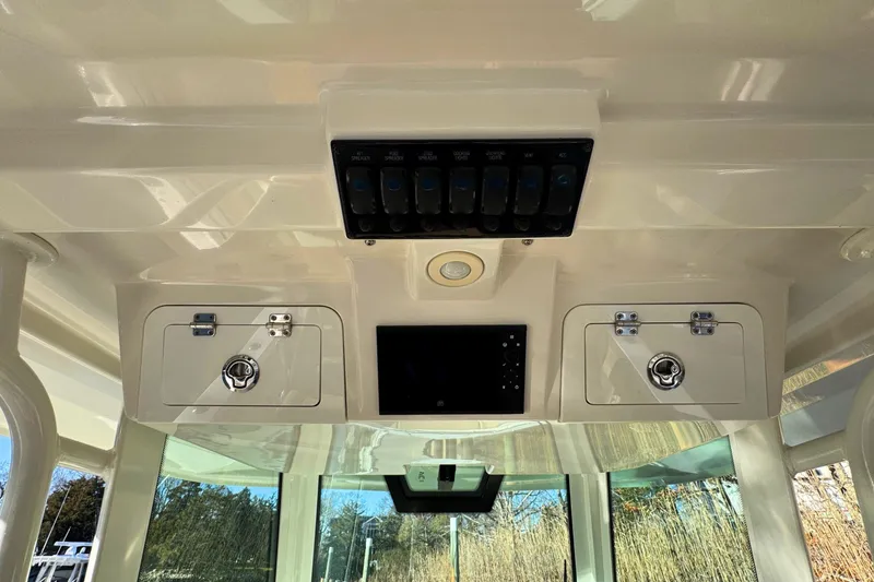 Slide: The Image of 2020 Sailfish 360 CC boat interior with beige seating, ocean view. - 27