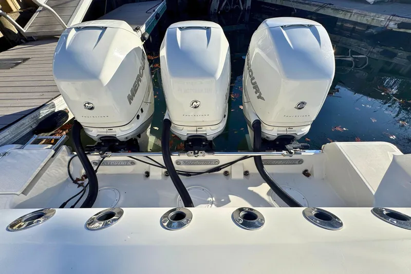 Slide: The Image of Triple Mercury outboard engines on a 2020 Sailfish 360 CC boat in open water. - 3