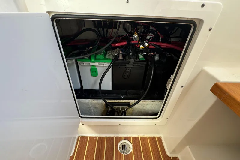 Slide: The Image of Battery compartment of a 2020 Sailfish 360 CC boat, showing wiring and connections. - 37