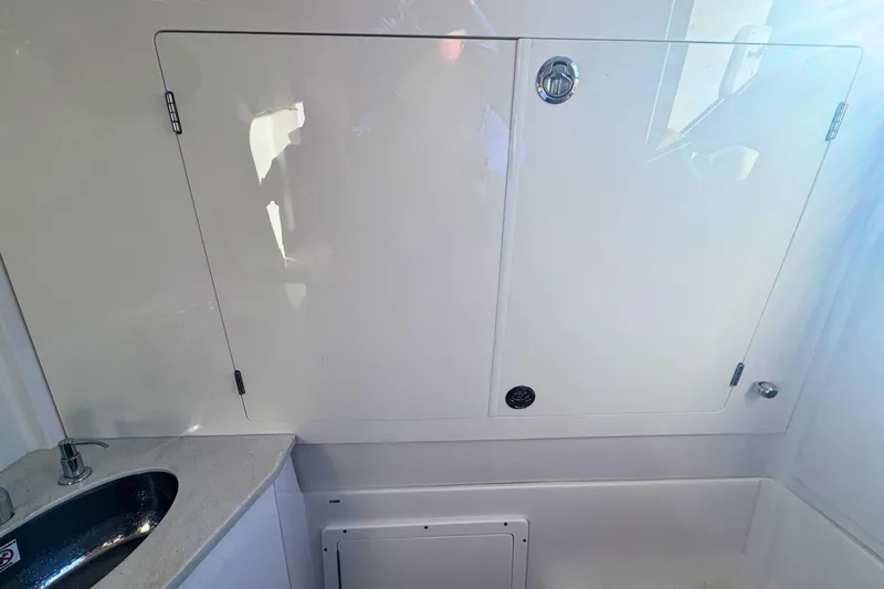 Slide: The Image of Interior of 2020 Sailfish 360 CC boat featuring a sleek sink and storage compartment. - 38