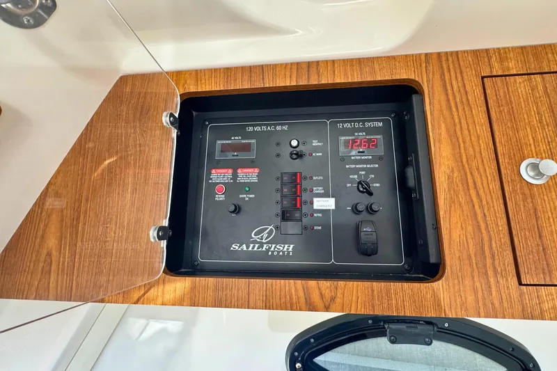 Slide: The Image of Control panel of 2020 Sailfish 360 CC boat with wood finish and electrical system display. - 42