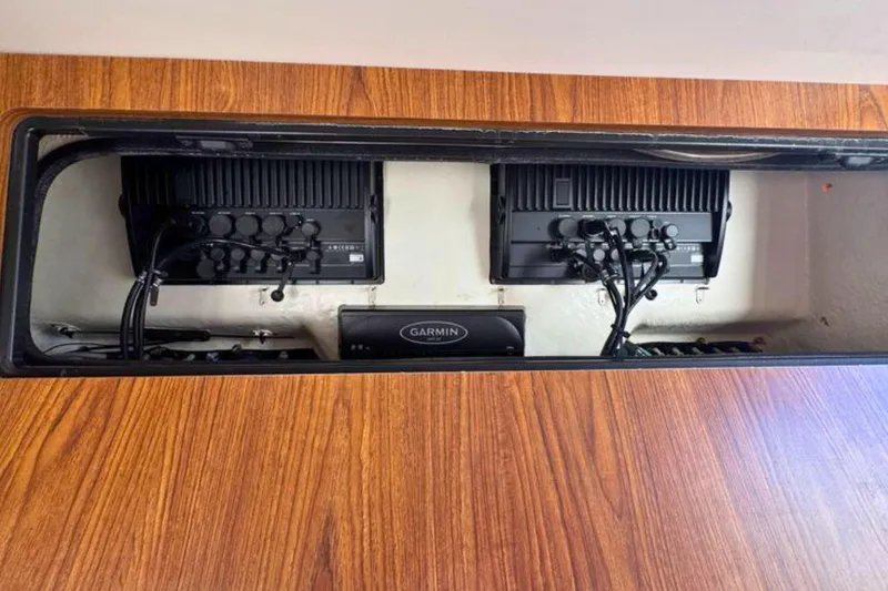 Slide: The Image of 2020 Sailfish 360 CC electronics compartment with Garmin equipment and wiring. - 43