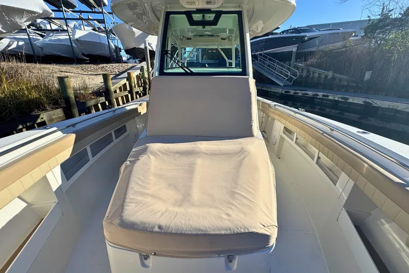 Slide: The Image of 2020 Sailfish 360 CC boat cruising on open water, featuring a comfortable deck lounge. - 45