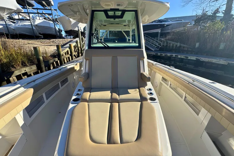 Slide: The Image of 2020 Sailfish 360 CC boat interior with cushioned seating, on a calm ocean. - 46