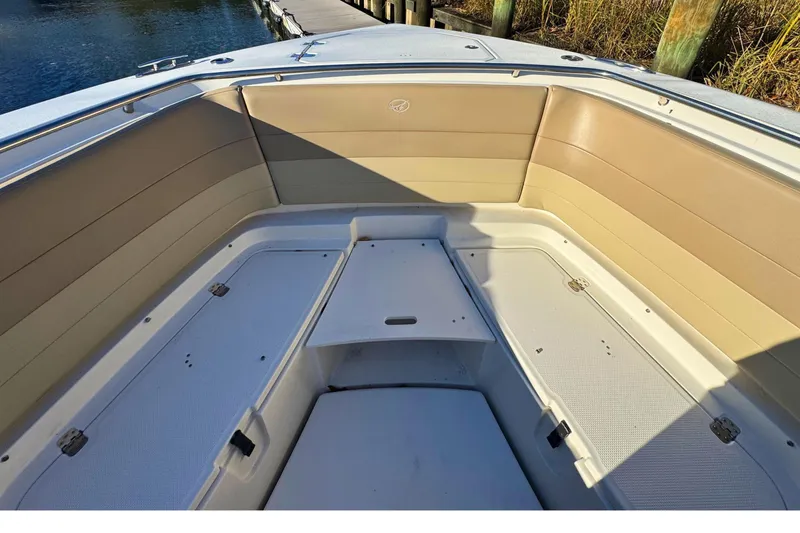 Slide: The Image of 2020 Sailfish 360 CC boat interior with tan seating, on open water. - 47