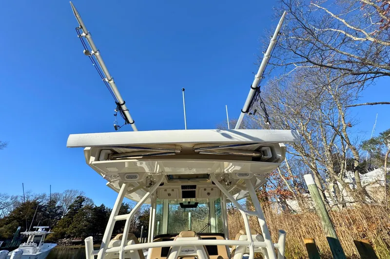 Slide: The Image of 2020 Sailfish 360 CC boat with fishing rods on a clear blue sea. - 51