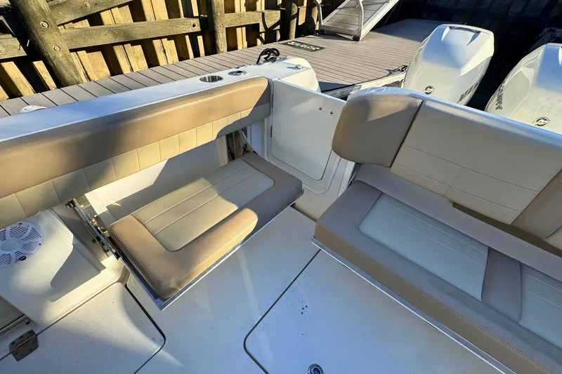 Slide: The Image of 2020 Sailfish 360 CC boat interior with cushioned seating, ocean view. - 7