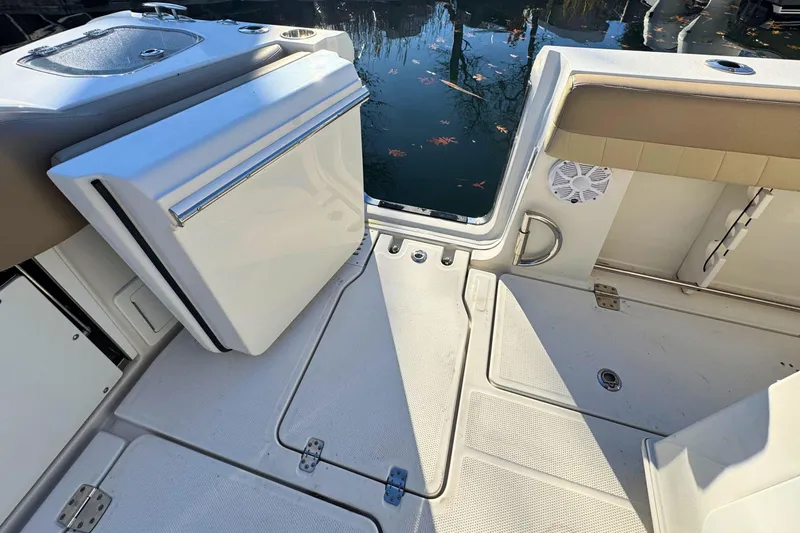 Slide: The Image of 2020 Sailfish 360 CC boat deck with open storage, overlooking the ocean. - 9
