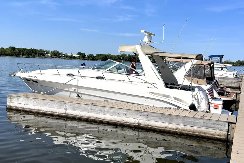 Slide: The Image of 2000 Sea Ray 340 Sundancer docked at a marina on a sunny day. - 13