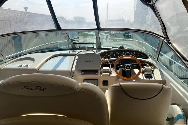 Slide: The Image of Cockpit of 2000 Sea Ray 340 Sundancer with Garmin navigation system and wooden steering wheel. - 2
