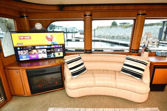 Slide: The Image of Luxurious 2001 Symbol Raised Pilothouse Motoryacht interior with plush seating and entertainment system. - 10