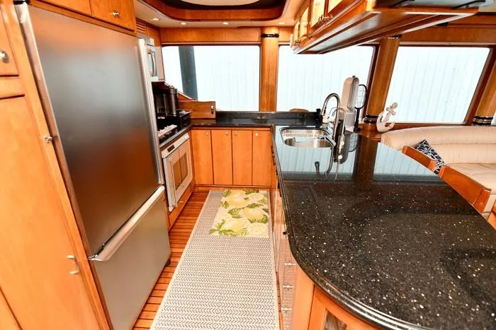 Slide: The Image of Luxurious kitchen in 2001 Symbol Raised Pilothouse Motoryacht with sleek countertops and modern appliances. - 13