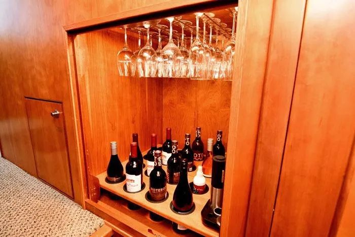 Slide: The Image of Luxurious yacht wine cabinet with glasses and bottles, Symbol Raised Pilothouse Motoryacht, 2001. - 14