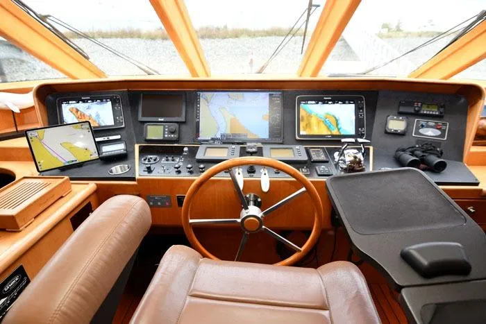 Slide: The Image of Pilothouse interior of 2001 Symbol Raised Pilothouse Motoryacht with navigation equipment and steering wheel. - 17