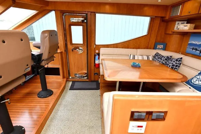 Slide: The Image of Luxurious 2001 Symbol Raised Pilothouse Motoryacht interior with seating and wooden accents. - 18