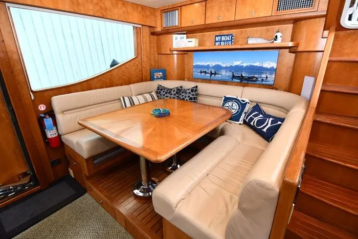 Slide: The Image of Luxurious 2001 Symbol Raised Pilothouse Motoryacht interior with elegant dining area and plush seating. - 20