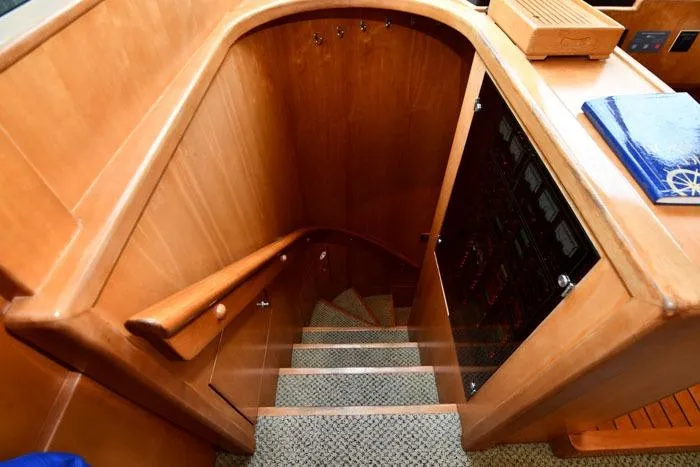 Slide: The Image of Staircase in 2001 Symbol Raised Pilothouse Motoryacht with wooden finish and carpeted steps. - 28