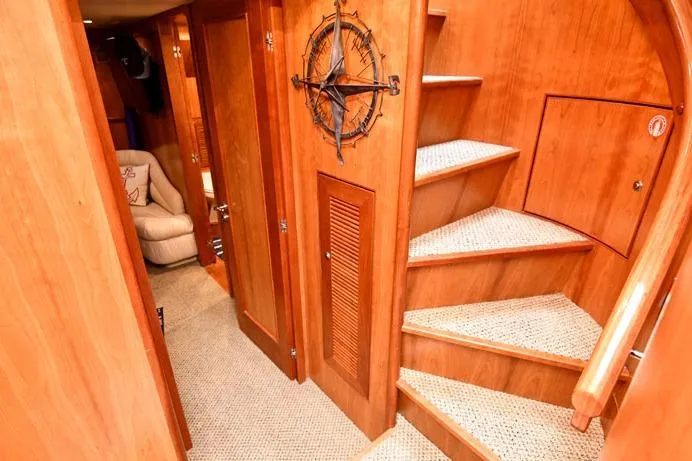 Slide: The Image of Luxurious wooden interior of 2001 Symbol Raised Pilothouse Motoryacht with spiral staircase. - 29