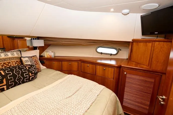 Slide: The Image of Luxurious bedroom in 2001 Symbol Raised Pilothouse Motoryacht with wood cabinetry and porthole window. - 30
