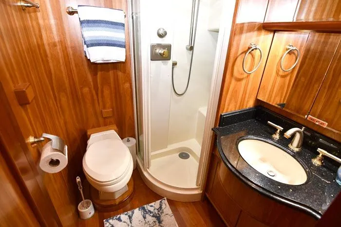 Slide: The Image of Luxurious bathroom in 2001 Symbol Raised Pilothouse Motoryacht with wood accents and modern fixtures. - 36