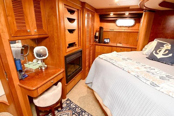 Slide: The Image of Luxurious 2001 Symbol Raised Pilothouse Motoryacht bedroom with wood finishes and cozy decor. - 38