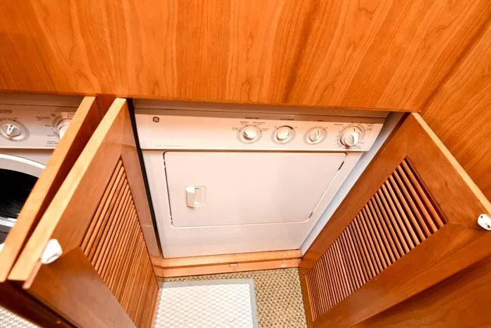 Slide: The Image of Laundry area with wooden cabinets on a 2001 Symbol Raised Pilothouse Motoryacht. - 40
