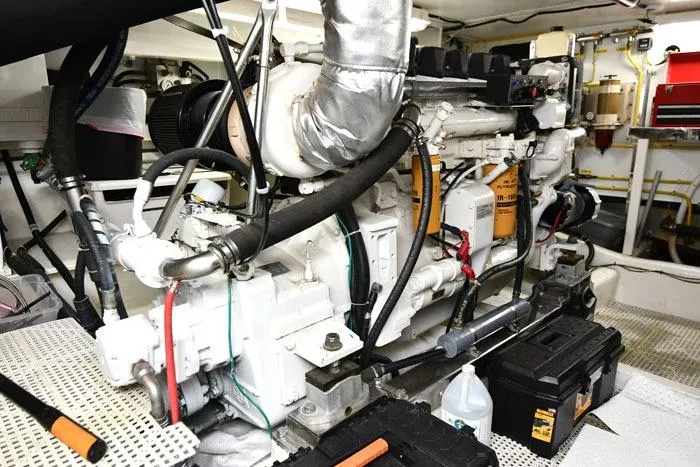 Slide: The Image of Engine room of 2001 Symbol Raised Pilothouse Motoryacht with visible machinery and tools. - 42