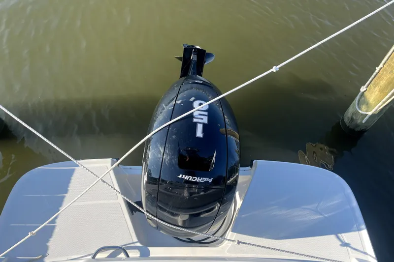 Slide: The Image of 2023 Bayliner VR6 Bowrider OB with Mercury 150 outboard engine, docked on calm water. - 9