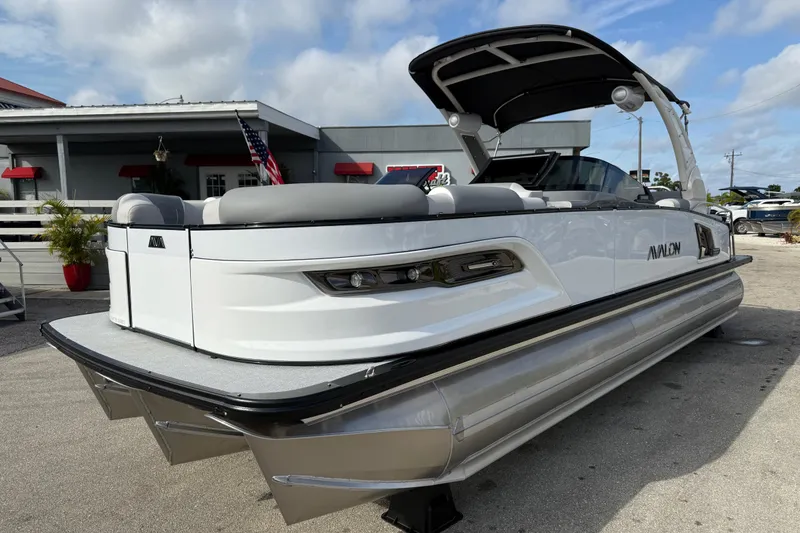 The Image of 2026 Avalon 2585 Excalibur LTD pontoon boat with Mercury V-10 motor, docked outdoors. - 1