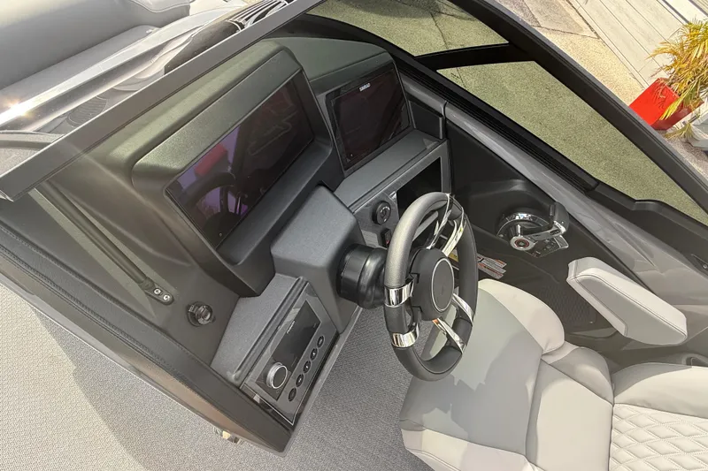 Slide: The Image of 2026 Avalon 2585 Excalibur LTD boat dashboard with modern steering and controls. - 19