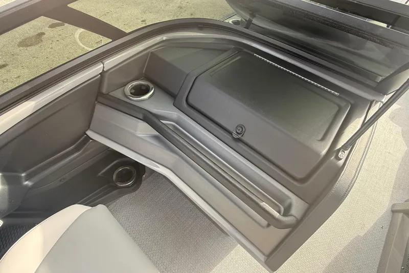 Slide: The Image of 2026 Avalon 2585 Excalibur LTD interior storage compartment with cup holders. - 21