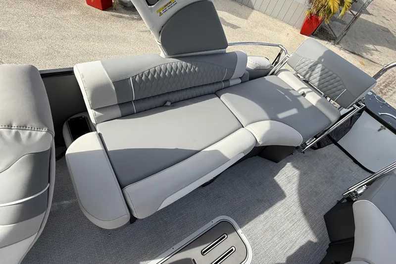 Slide: The Image of 2026 Avalon 2585 Excalibur LTD boat interior with luxurious gray seating and loungers. - 24