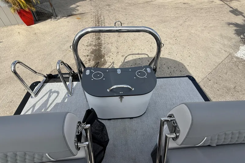 Slide: The Image of 2026 Avalon 2585 Excalibur LTD boat interior with gray seating and control panel. - 26