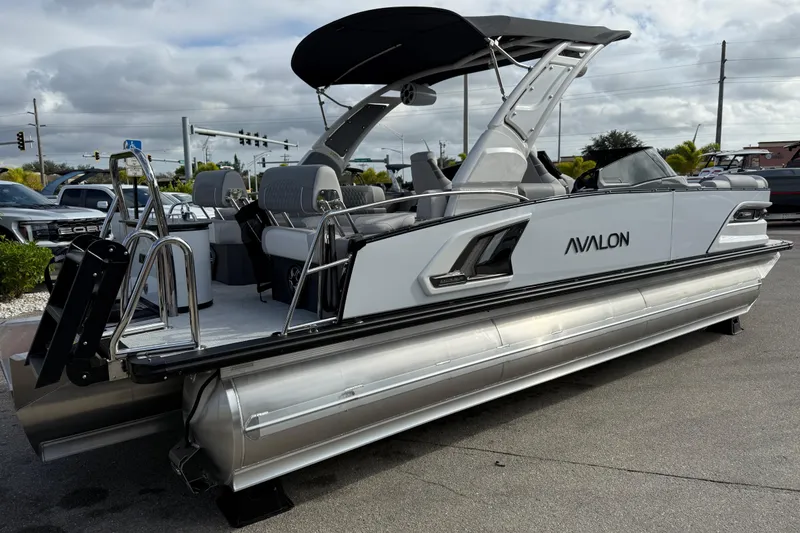 Slide: The Image of 2026 Avalon 2585 Excalibur LTD Tri Toon boat with Mercury V-10 motor, sleek design. - 5