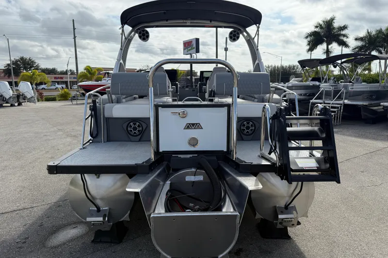 Slide: The Image of 2026 Avalon 2585 Excalibur LTD boat with Mercury V-10 motor, rear view, docked outdoors. - 6