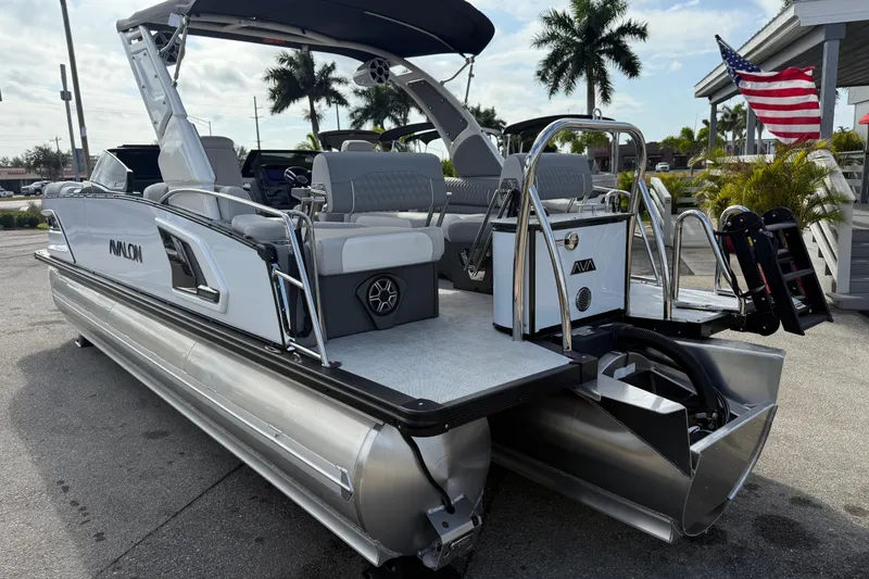 Slide: The Image of 2026 Avalon 2585 Excalibur LTD pontoon boat with Mercury V-10 motor, parked outdoors. - 7