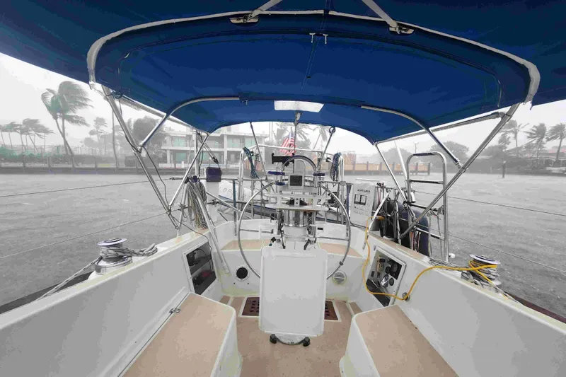 Slide: The Image of Cockpit view of 1979 Tartan T 37 sailboat with blue canopy in stormy weather. - 11