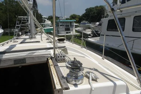 Slide: The Image of 1979 Tartan T 37 sailboat deck with winch and rigging in marina. - 12