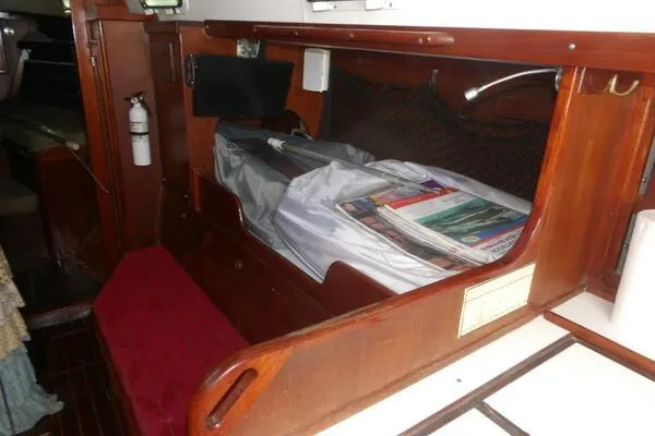 Slide: The Image of 1979 Tartan T 37 yacht interior with wooden cabinetry and storage area. - 24