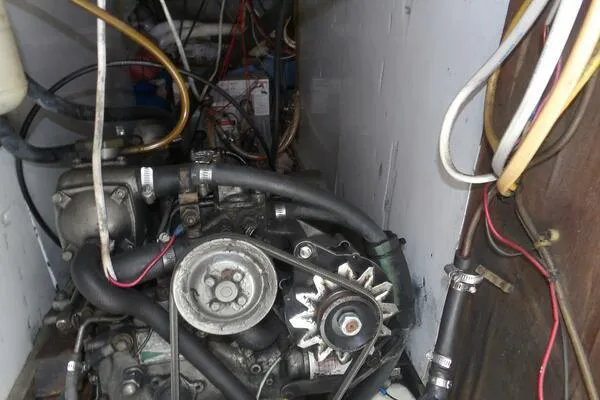 Slide: The Image of Engine compartment of a 1979 Tartan T 37 sailboat, showing mechanical components and wiring. - 44