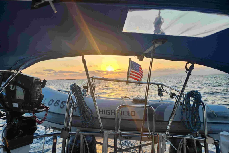 Slide: The Image of Sailing at sunset on a 1979 Tartan T 37 with American flag. - 13