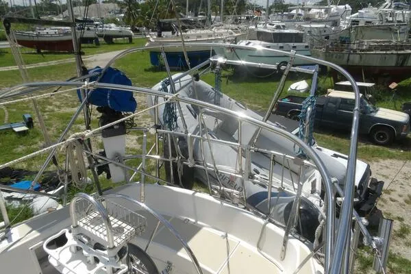 Slide: The Image of 1979 Tartan T 37 sailboat in a boatyard, surrounded by other vessels and equipment. - 17